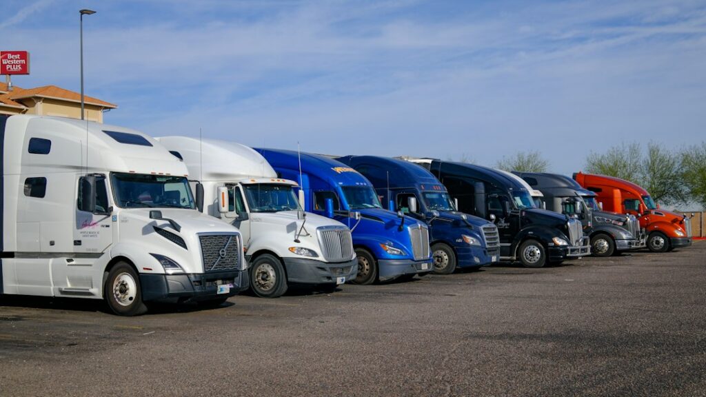 Commercial trucks lined up at a dealership or fleet facility, representing dealer financing opportunities.